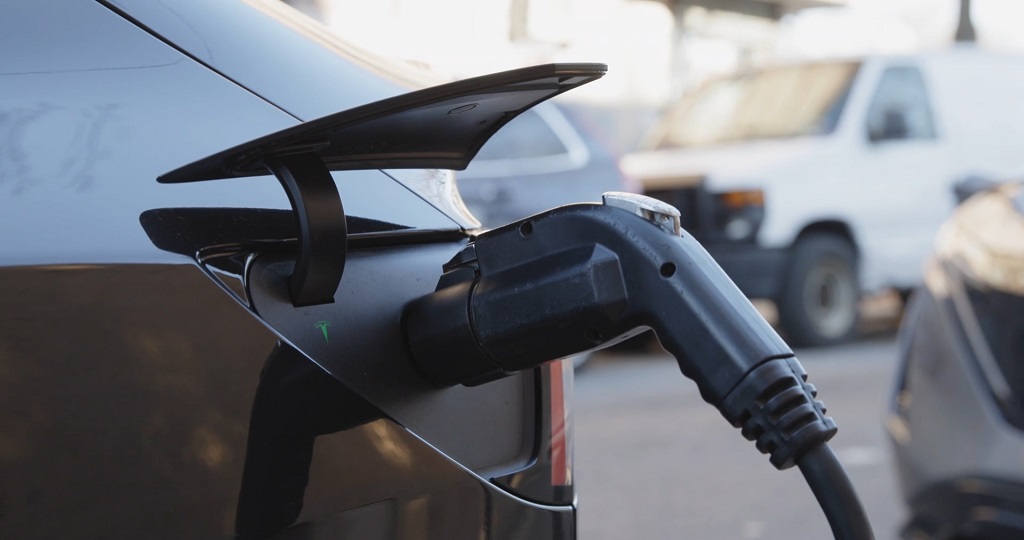 Close-up of EV charging port in use, addressing a previously dead battery