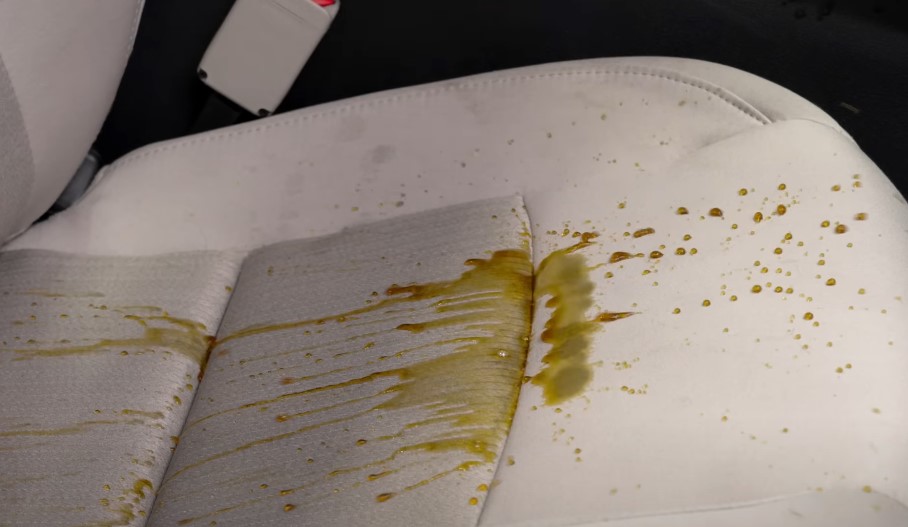 Spilled coffee, creating a sticky mess on the car seat