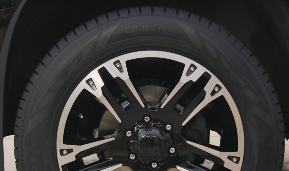 Close up view of a car's front left wheel and tire