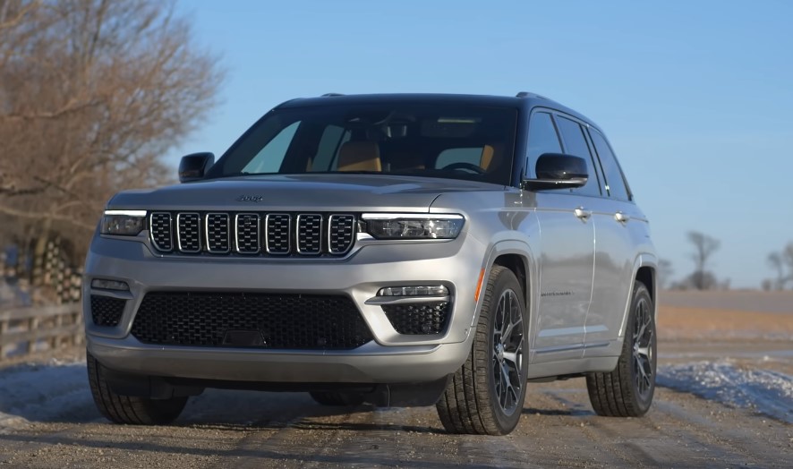 Silver Jeep Grand Cherokee parked on a road