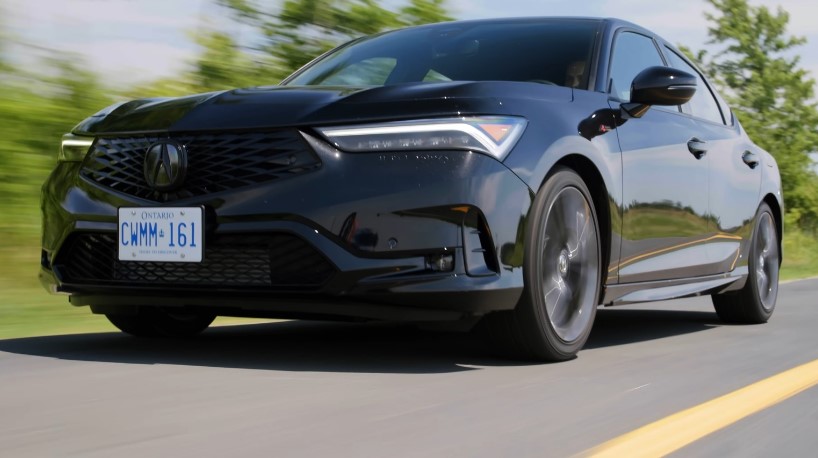 Sleek black Acura Integra sedan gliding down the road