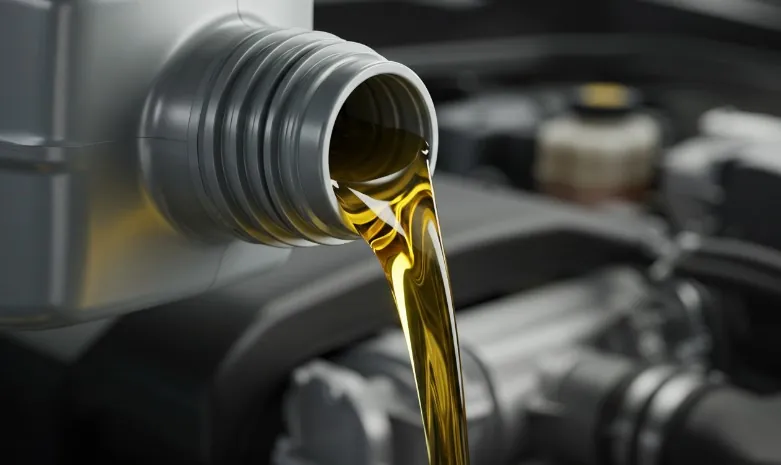 Close-up view of oil pouring into an engine
