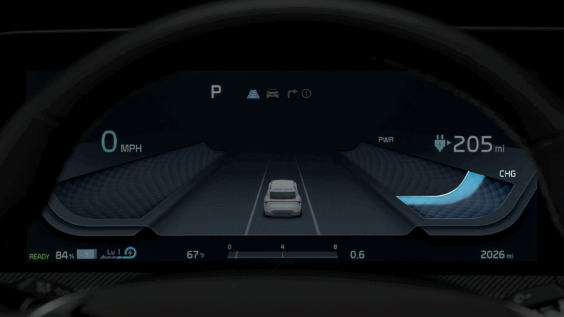 Close-up of a digital instrument cluster in an electric vehicle showing speed, range, and driving data