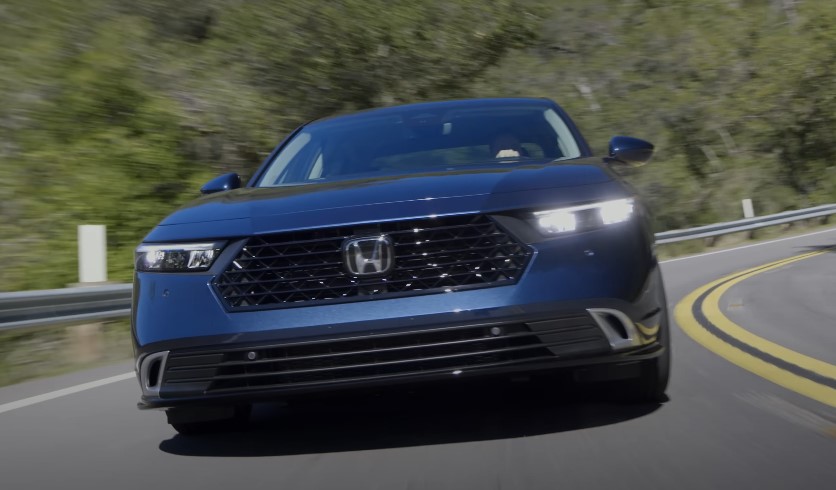 Dark Honda Accord hiting curve on the road