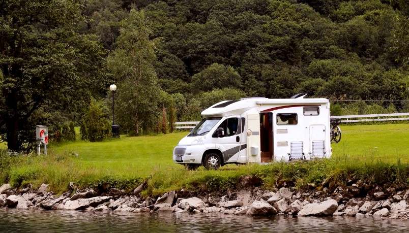 Tranquil campervan parked beside a serene river