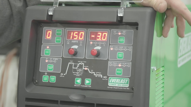 Close-up of a MIG pulse welder control panel showing active settings