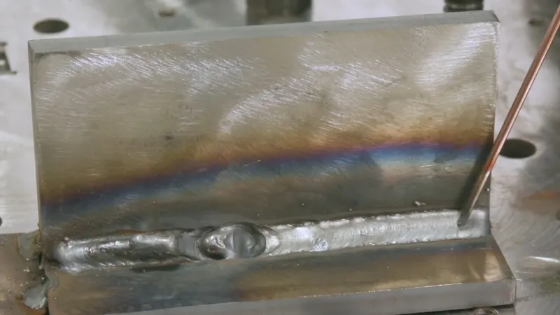 MIG pulse weld on metal showing signs of overheating and heat discoloration near the joint