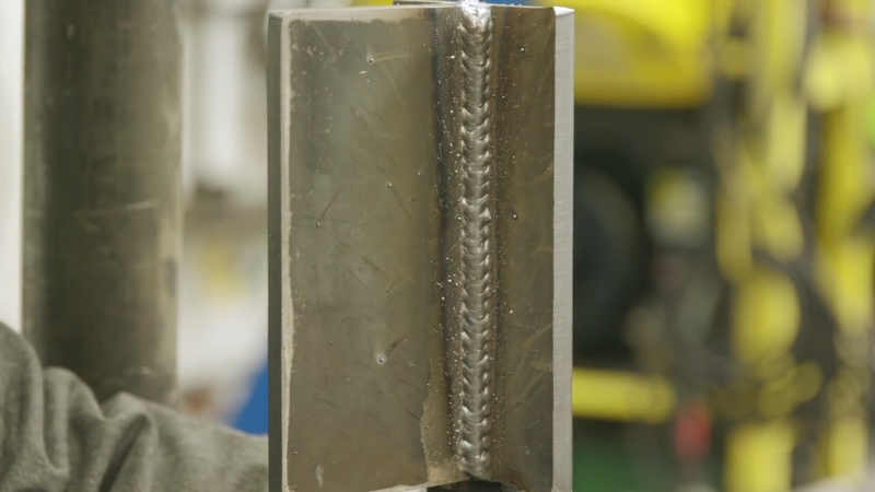 Close-up of a clean vertical MIG weld on a metal joint