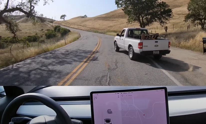 A pickup truck, loaded with cargo, moves along a country road