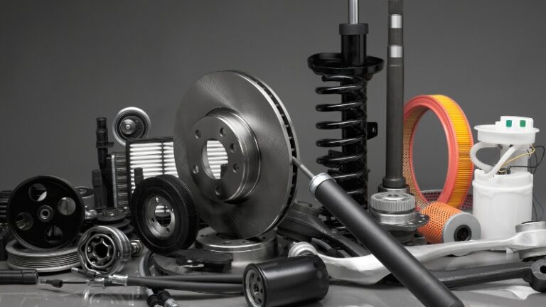 Assorted auto parts displayed together, highlighting some of the most expensive EV parts to replace