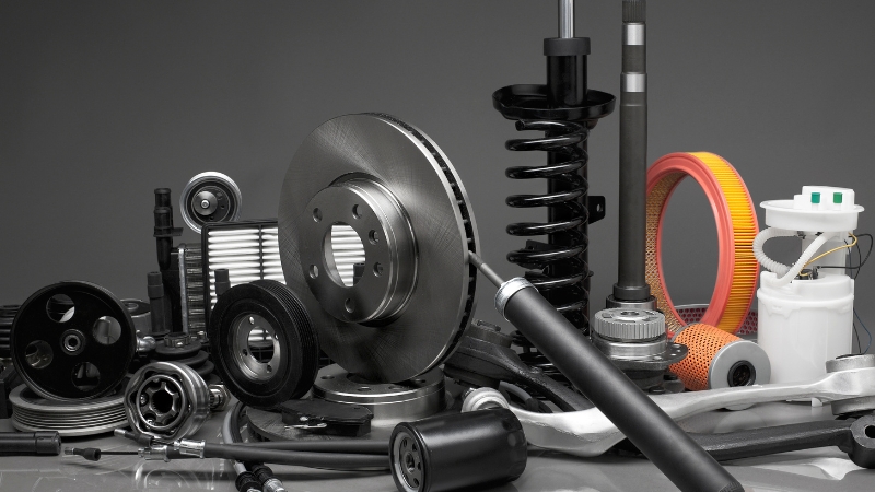 Assorted auto parts displayed together, highlighting some of the most expensive EV parts to replace