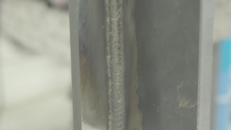 Close-up of a clean MIG pulse weld bead on a metal joint