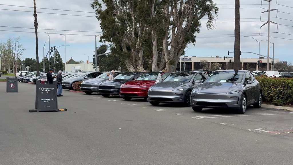 Tesla vehicles parked at dealership lot, representing finance with a loan option