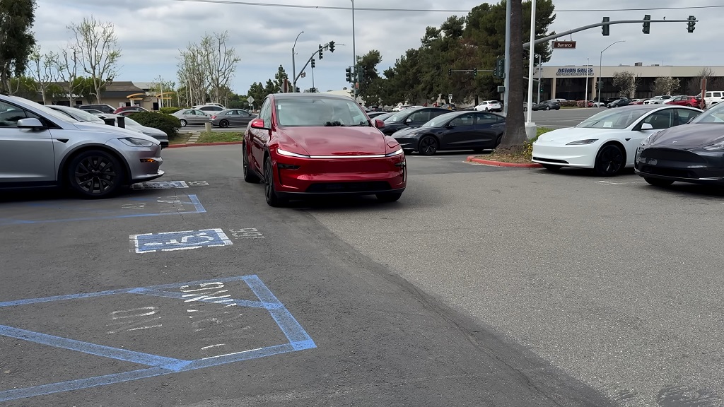 Tesla and other electric cars parked in a lot, illustrating how Tesla leases work