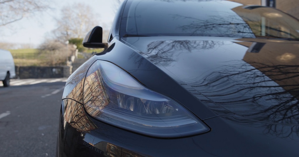Close-up of a sleek black Tesla car, symbolizing paying cash purchase option