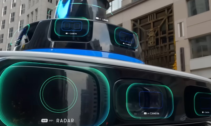A sleek futuristic car featuring large lidars and radars