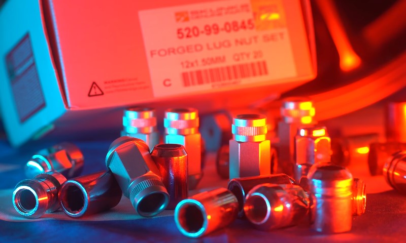 A close-up of a box filled with various seat nuts