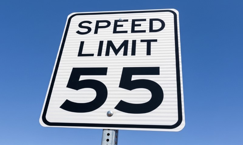Speed limit sign displaying "Speed Limit 55" in bold black letters on a white background