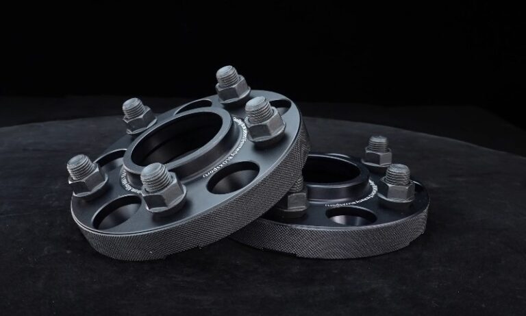 A pair of precision-machined wheel spacers with accompanying lug nuts