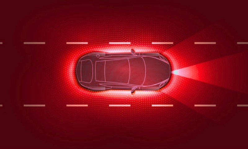 Wireframe vehicle surrounded by a luminous red warning aura on a dashed white-lined highway