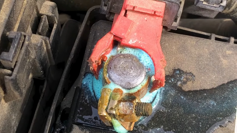 Corroded battery terminals show heavy buildup that needs cleaning for solid electrical contact