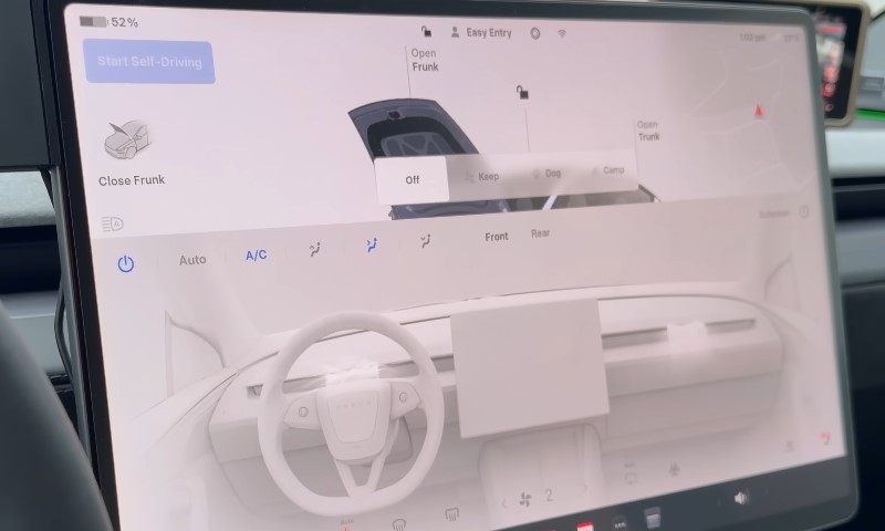 Interior view of a Tesla Model 3, showcasing a minimalist dashboard