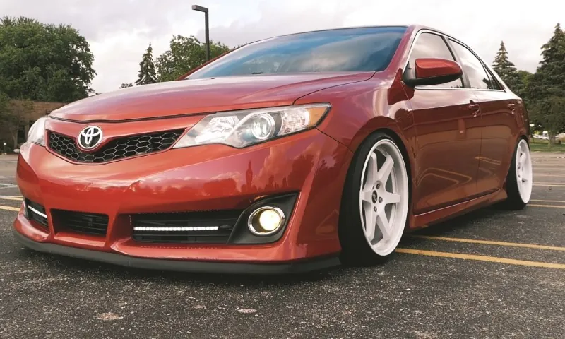 Red Toyota Camry parked on the road